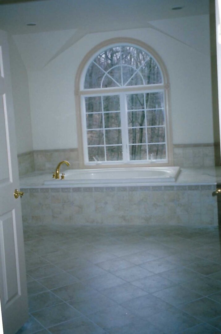 a bathtub beside a window