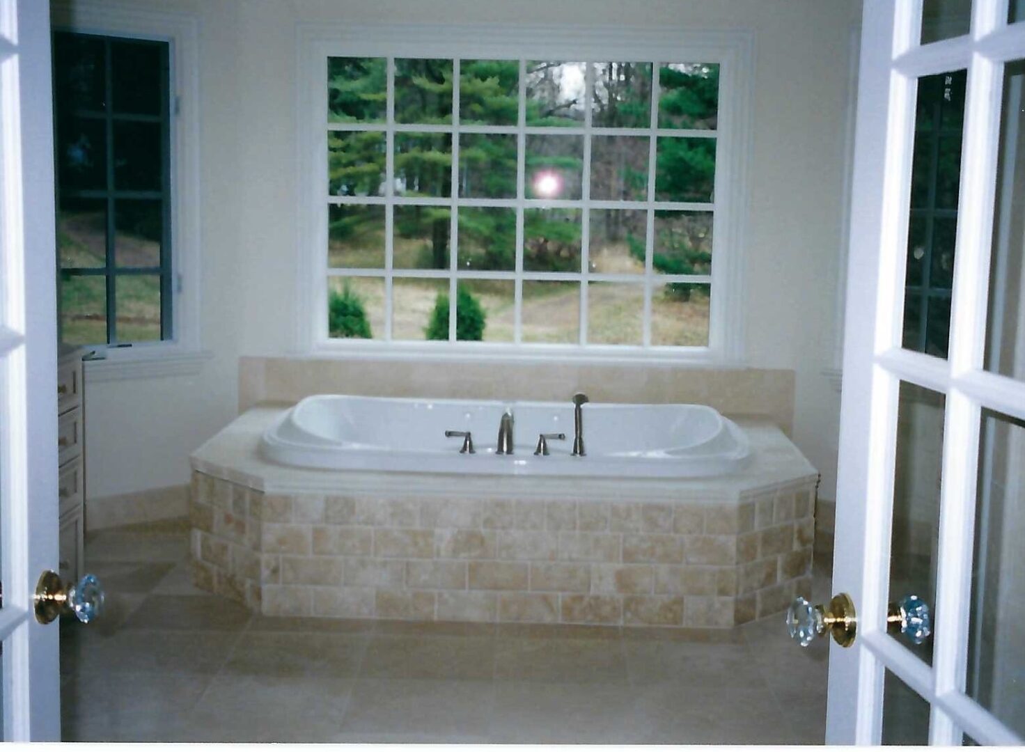 a tub deck beside a window