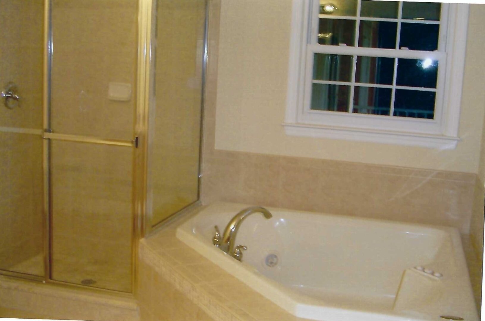 a small tub deck beside a shower enclosure