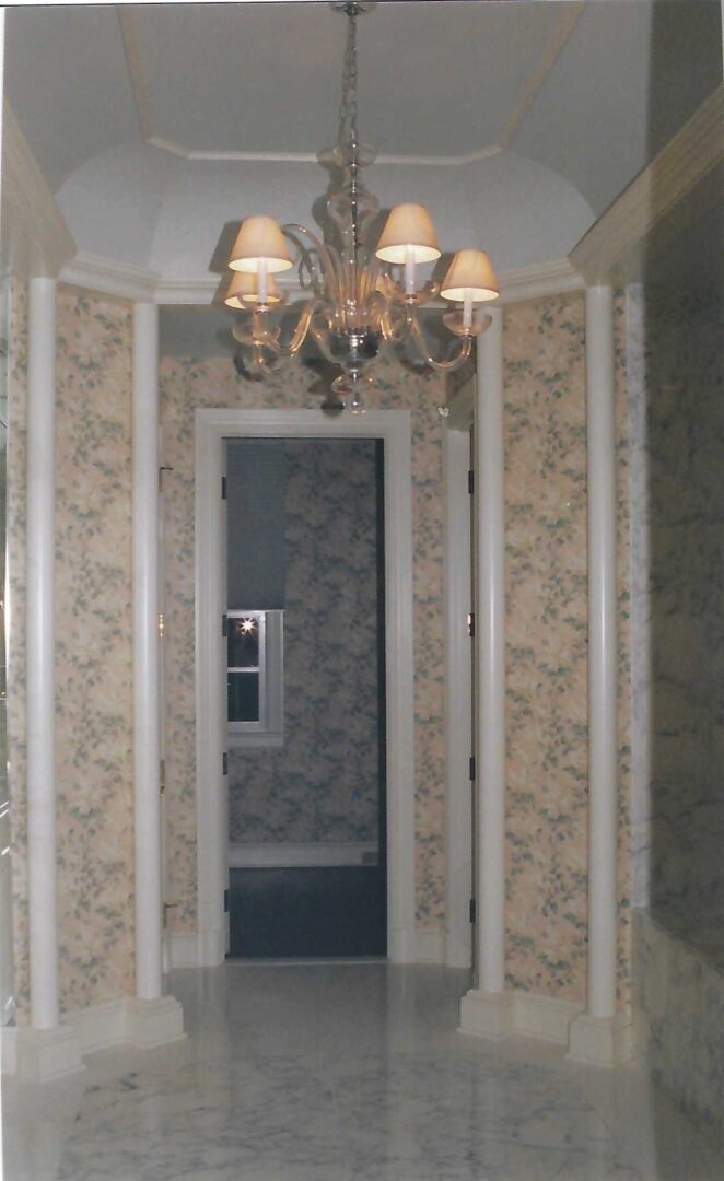 a hallway with a chandelier