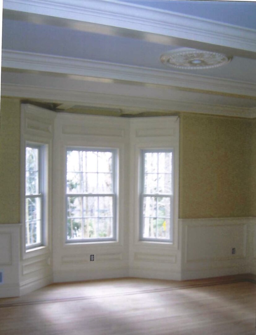 a room with a three-panel casement window